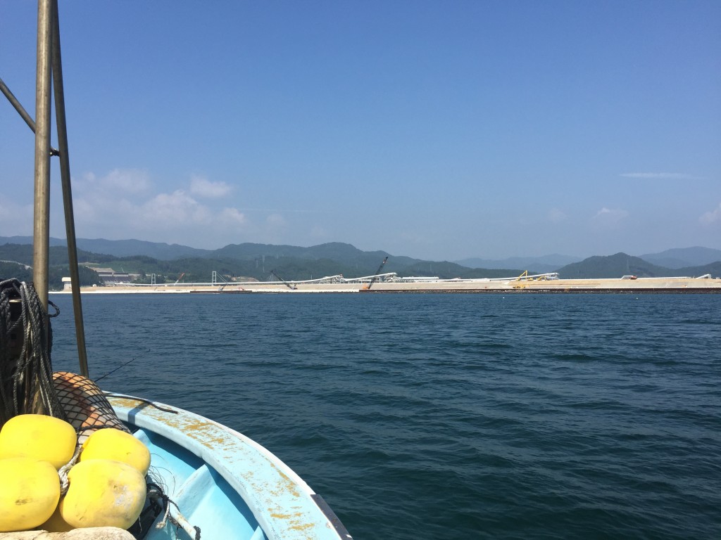 船から見た陸前高田の眺め。ベルトコンベアが運ぶ土で土地のかさ上げが進む